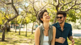 Young happy couple walking together in the park