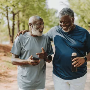 Two Men Walk and Laugh Through a Park