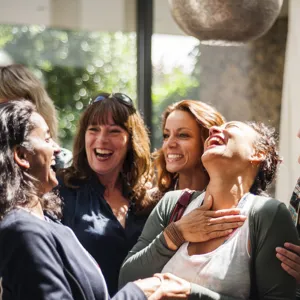 A group of women laugh together.