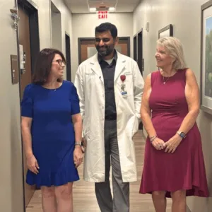 Two women walking with a doctor