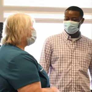 Becky Bringhurst and Desmond Yeboah visit about his recovery process.