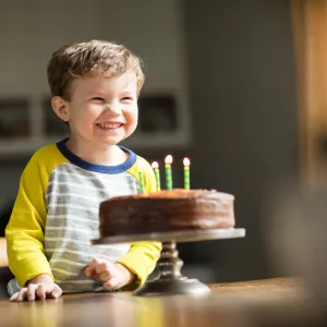 Child excited for his birthday cake