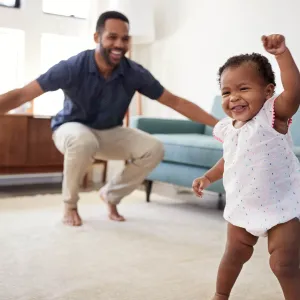 A father and baby playing at home.