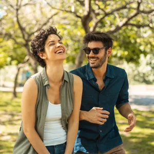 Young happy couple walking together in the park
