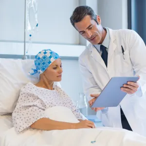 Physician showing information to patient related to brain surgery