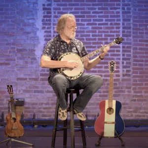 Jim Pankey playing banjo on stage