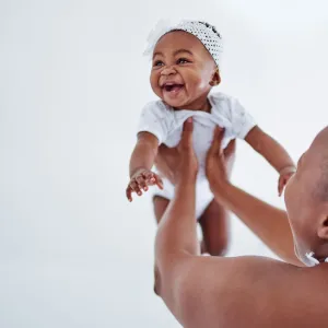 Mother holding up her baby.