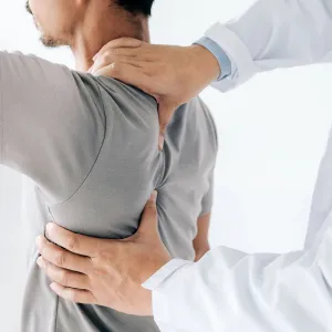 A man having his spine examined.