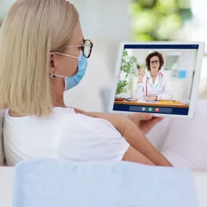 A woman visiting with a virtual doctor.