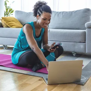 A woman preparing to exercise in her living room.