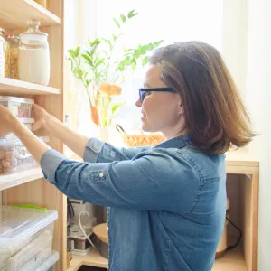 A woman organizing her pantry.