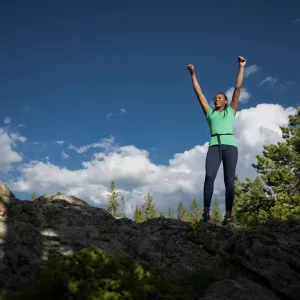 Woman on top of cliff.