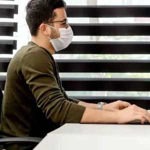 A man at work wearing a face mask.
