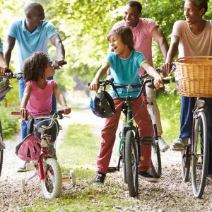 Multigenerational family riding bikes together.