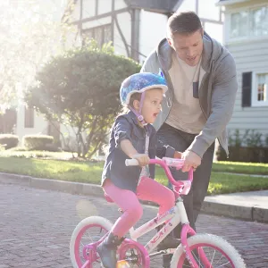 Dad taking his daughter on a bike ride.