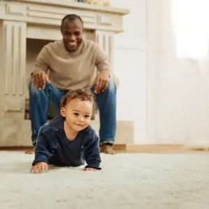 man with baby crawling