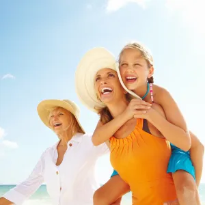 Tri-Generational family of women walking together on the beach
