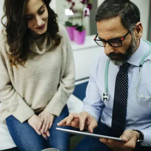 Woman discussing treatment with doctor