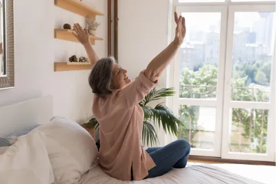 A Woman Stretches After Waking From Sleep