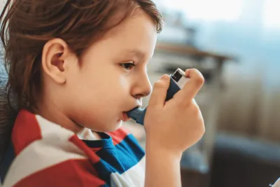 A child using an inhaler.