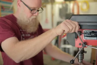 Mat Germann operating a drill press.