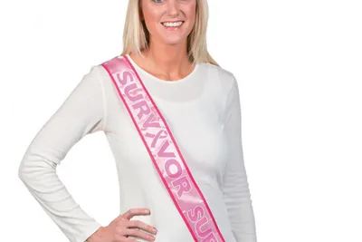 Woman wearing breast cancer survivor sash