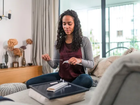 Black woman taking at home COVID-19 test