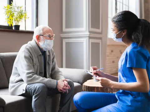A Patient Speaks with a Provider in the Lobby of a Medical Practice.