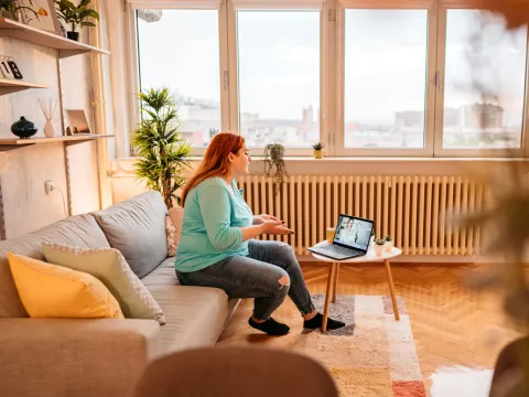 A Patient Speaks to Her Doctor Via Laptop During a Telehealth Visit