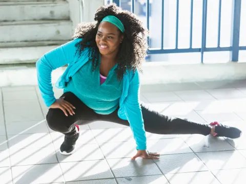 A Woman Stretches Before Going For a Run