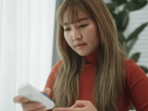 A Woman Checks Her Glucose Monitor