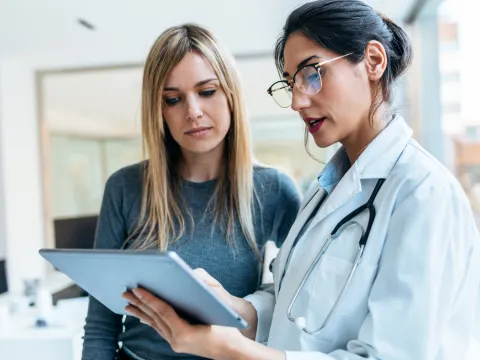 A Doctor Goes Over a Chart with a Patient