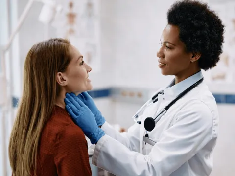 A Physician Checks Her Patient's Throat in a Practice Office.