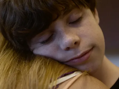 Cory and her son in an embrace.