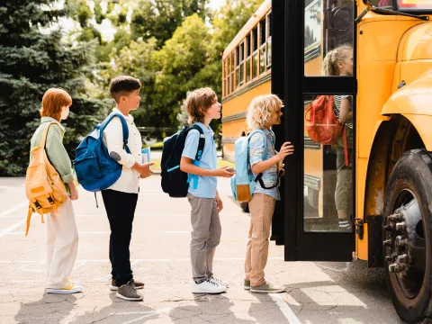 Children waiting to get on the school bus.