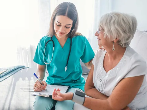 Nurse checking patients blood pressure.