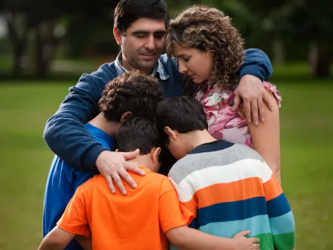 A family hugs and counts their blessings.