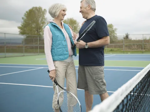 Senior couple playing tennis