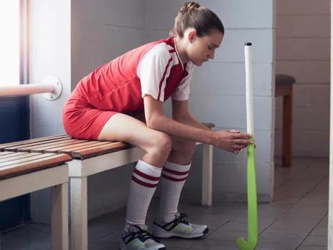 A teenage athlete taking a break in the locker room.