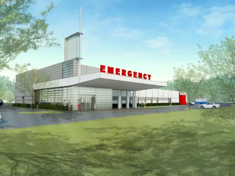 Drawn rendering of a Emergency Room building--white with red Emergency letters, surrounded by green space.