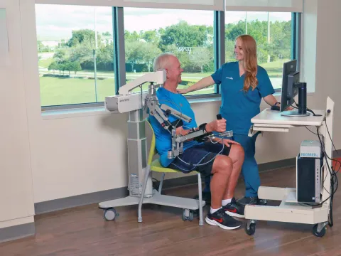 A Provider Helps a Patient with Neurological Physical Therapy