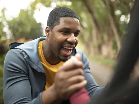 Man laughing outdoors