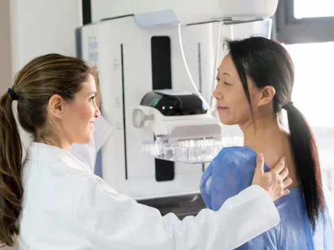 A woman about to receive a mammogram.