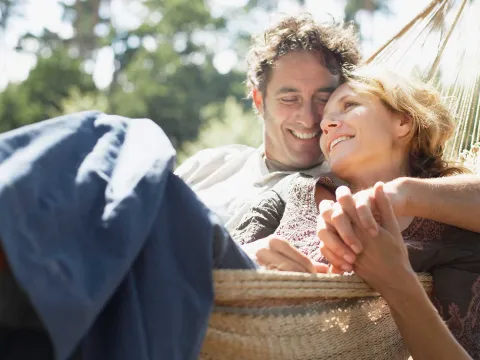 A romantic couple enjoying their time together on a hammock