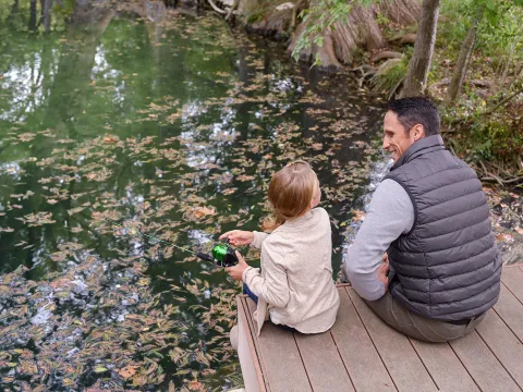 Father took his daughter fishing.