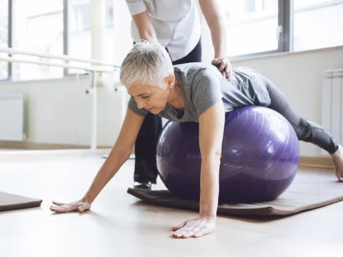 woman exercising with a fitness trainer
