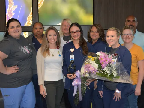 Group of people holding flowers.