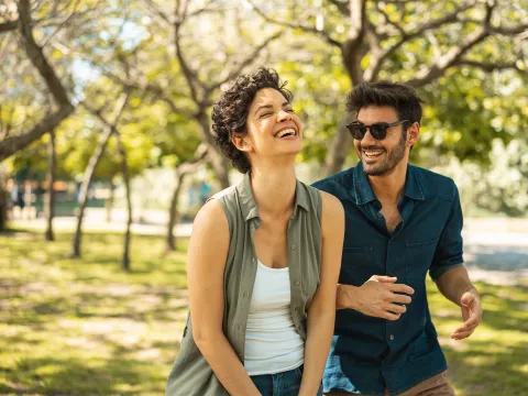 Young happy couple walking together in the park
