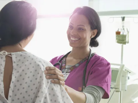 A Nurse Speaks to a Patient with Happy News