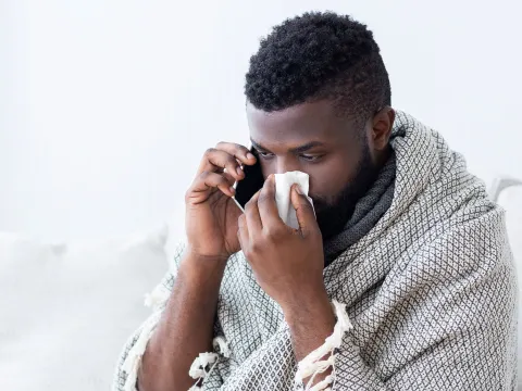 A man calling his doctor about his symptoms.